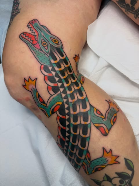 Colorful traditional alligator tattoo with patterned scales